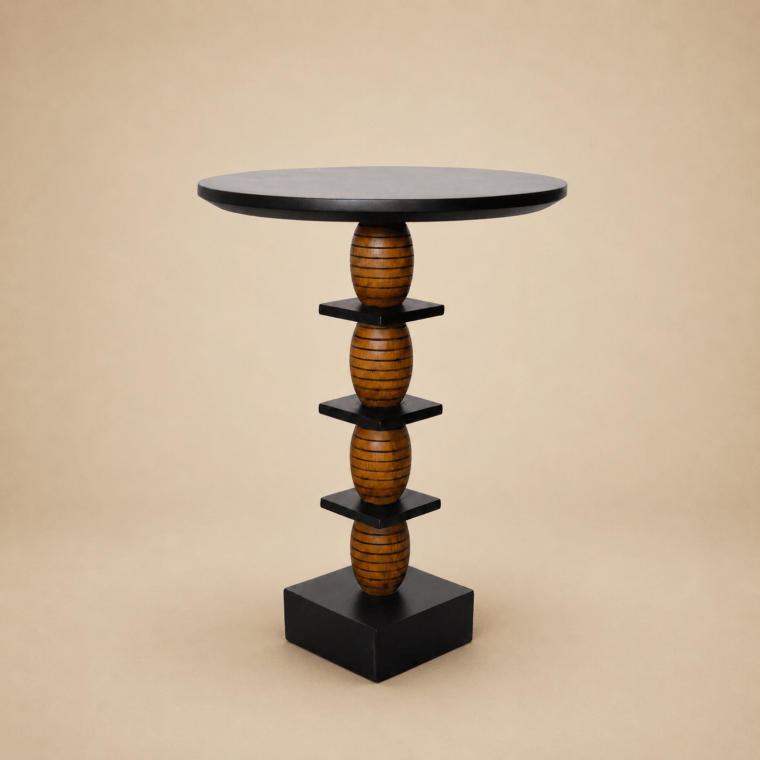 Maala end table with a stacked lathe-turned wood column and black disc top, on a neutral backdrop