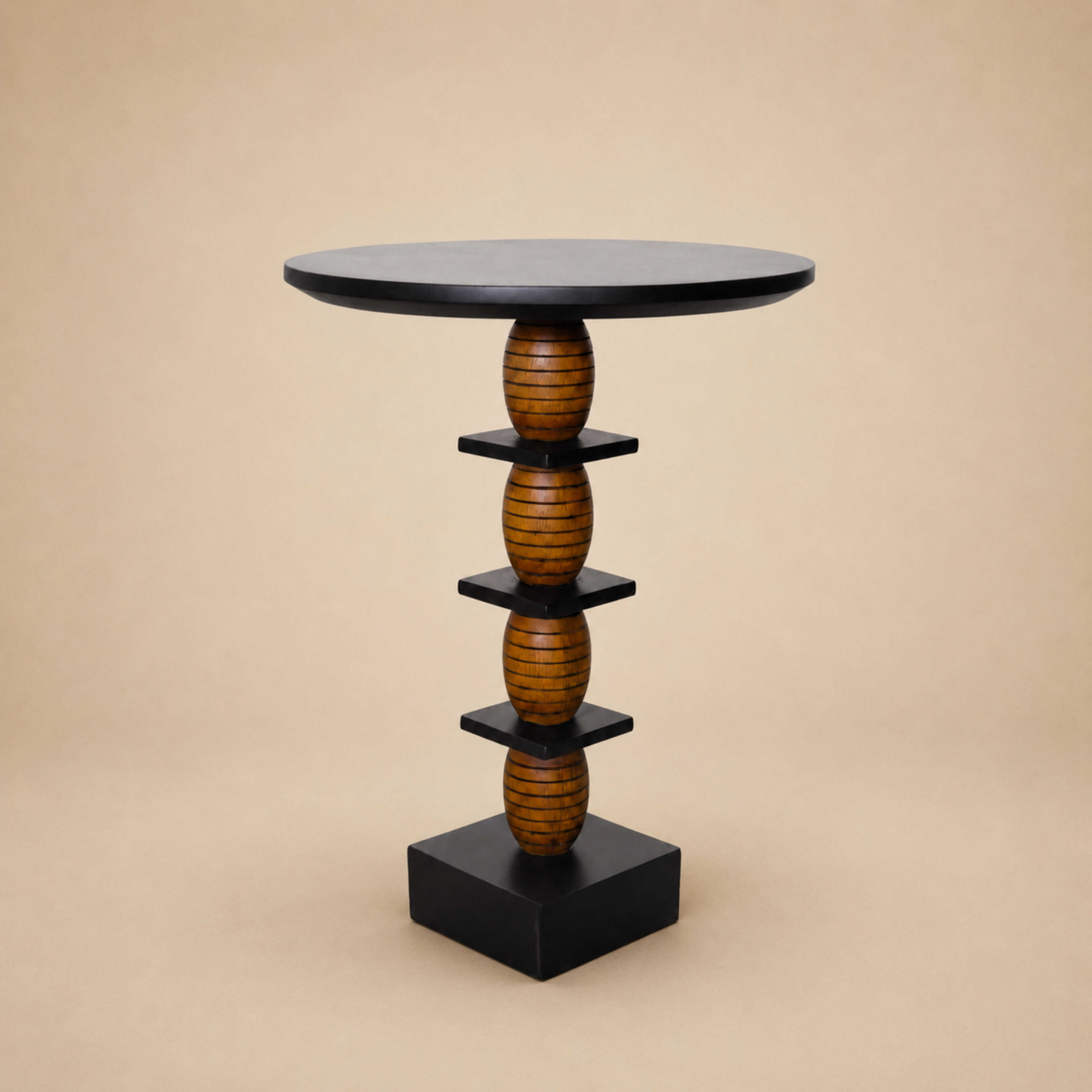Maala end table with a stacked lathe-turned wood column and black disc top, on a neutral backdrop